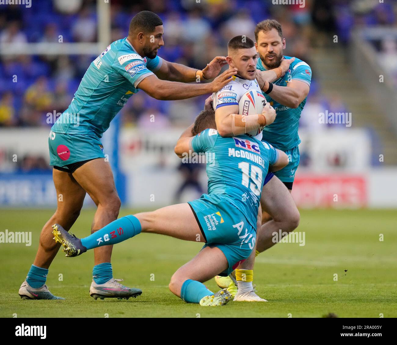Warrington, UK. 29th June, 2023. Danny Walker #16 of Warrington Wolves is tackled by James McDonnell #19 of Leeds Rhinos during the Betfred Super League Round 17 match Warrington Wolves vs Leeds Rhinos at Halliwell Jones Stadium, Warrington, United Kingdom, 29th June 2023 (Photo by Steve Flynn/News Images) in Warrington, United Kingdom on 6/29/2023. (Photo by Steve Flynn/News Images/Sipa USA) Credit: Sipa USA/Alamy Live News Stock Photo