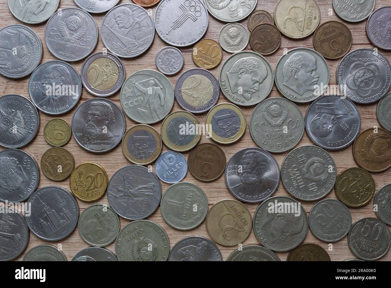 Collection of old coins close-up on a wooden background. Stock Photo