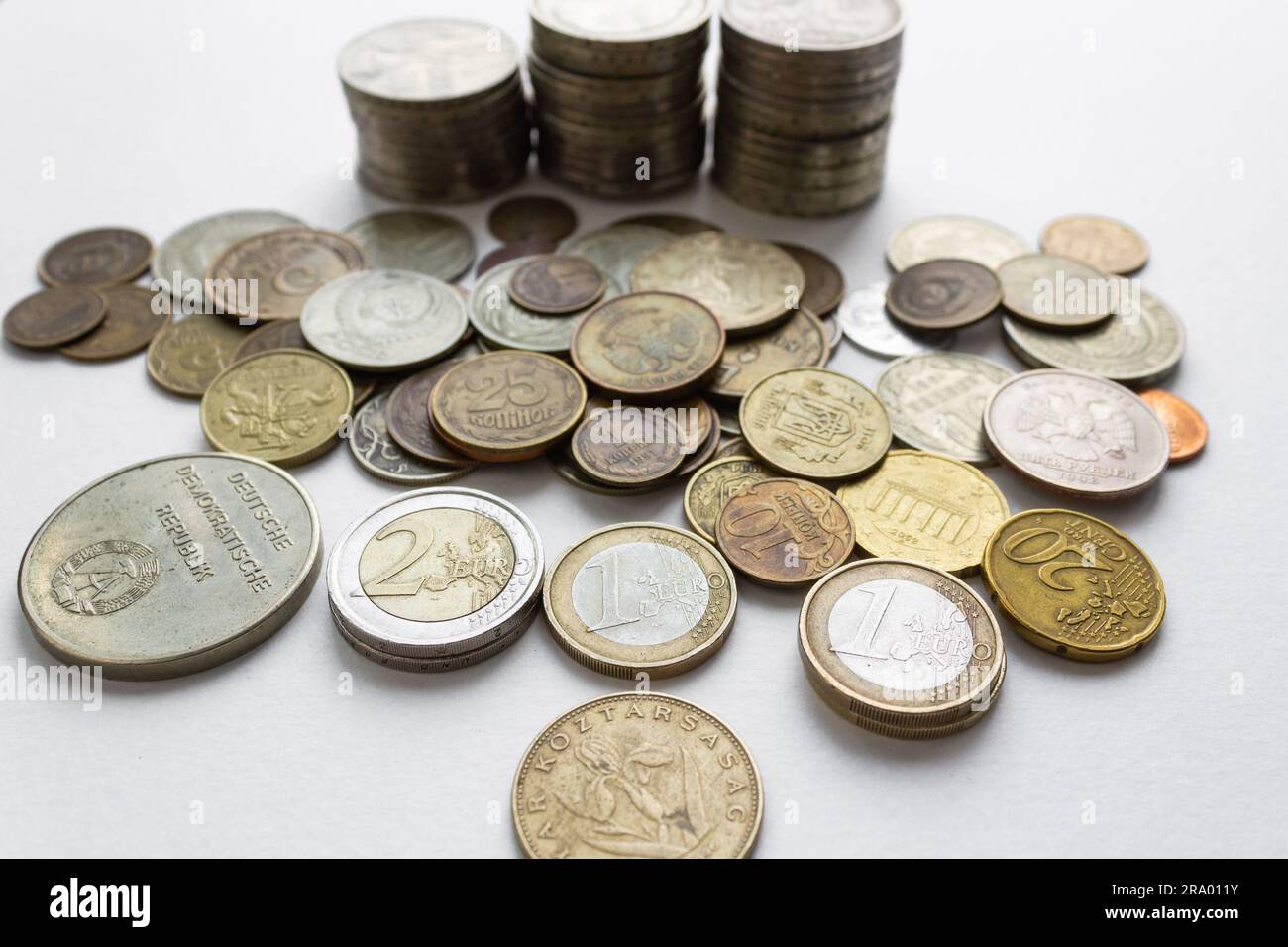 Collection of coins from different countries and times on a white background. Stock Photo