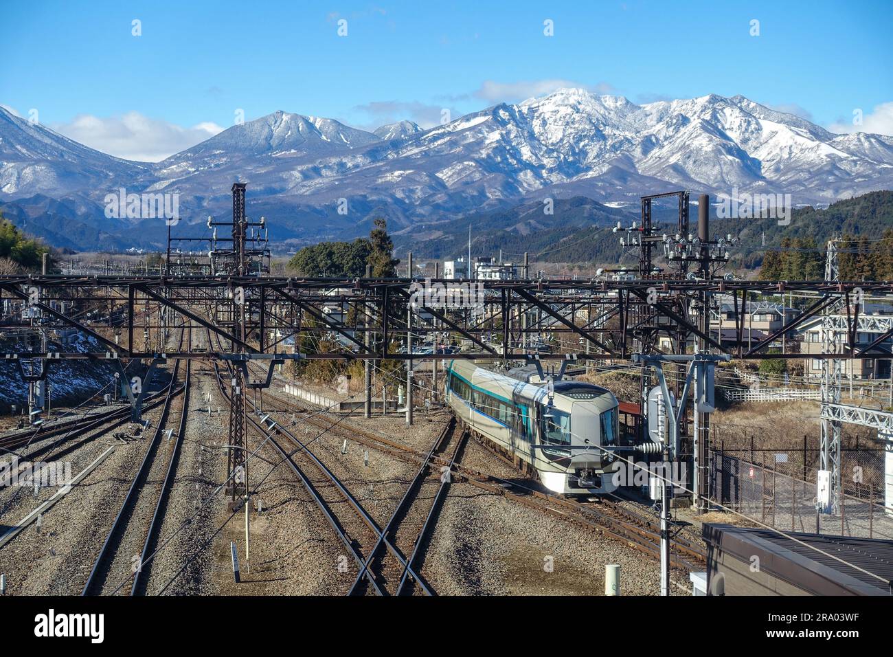 Nikko train station, rails, with snowy Japanese Alps in the backgound Stock Photo