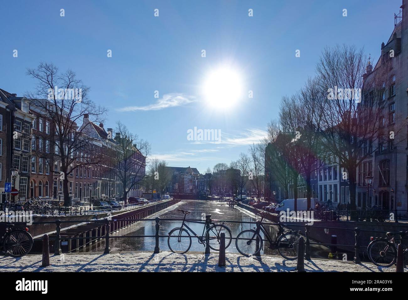 Bicycles and boats over the frozen canals of Amsterdam Stock Photo