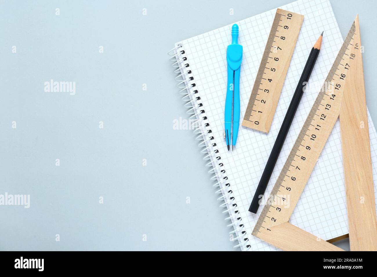 Different rulers and compass on light grey background, flat lay. Space ...