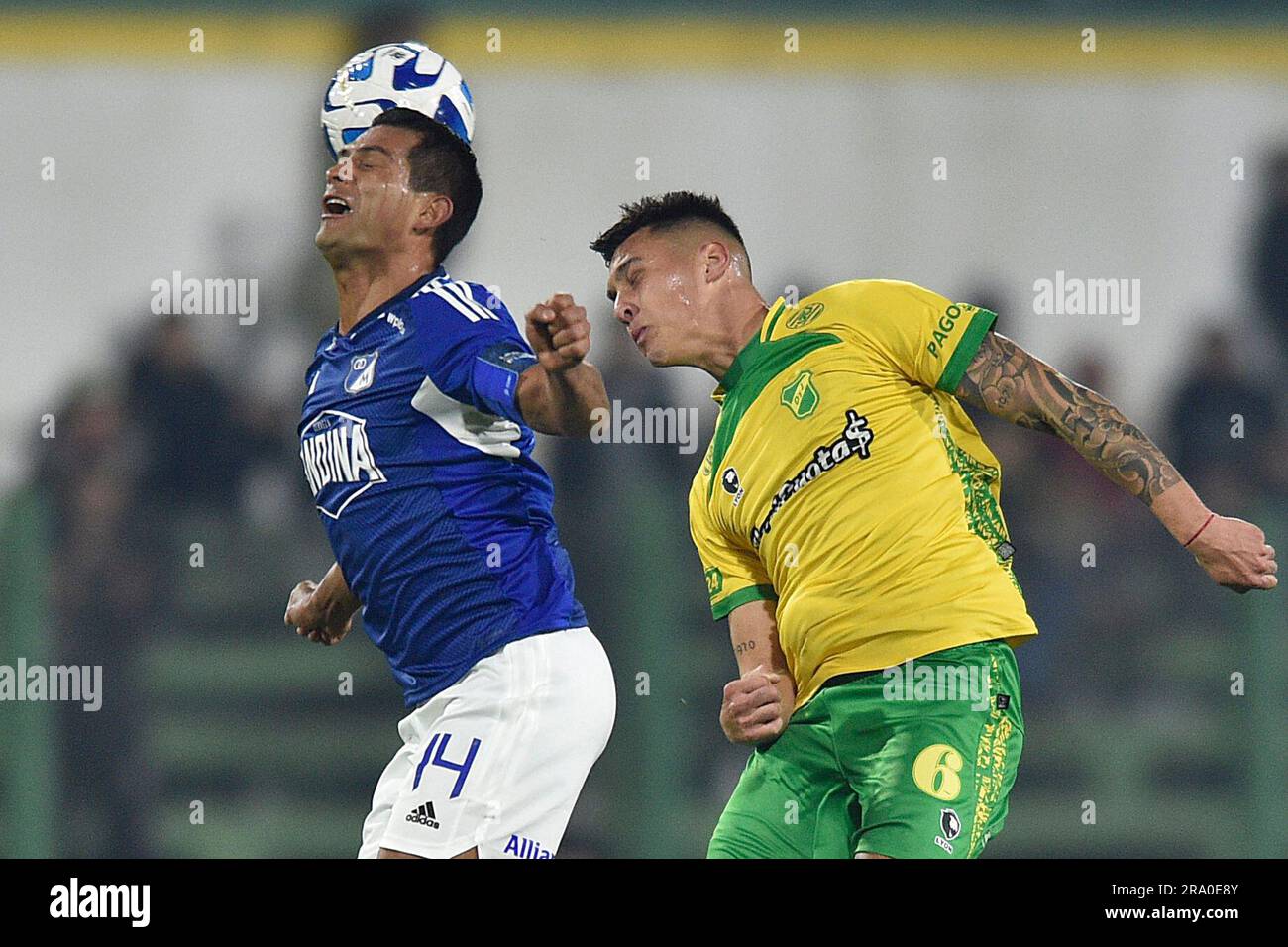 David Silva of Colombia's Millonarios, left, heads to score his side's  opening goal against Brazil's Atletico Mineiro during a Copa Libertadores  soccer match at El Campin stadium in Bogota, Colombia, Wednesday, March