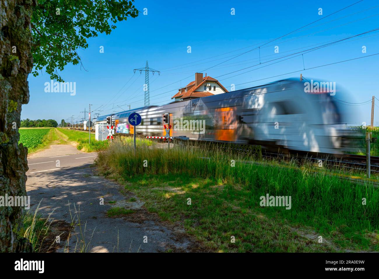 Fast train, in motion, motion blur, passed, level crossing, Germany, North Rhine-Westphalia, Beckrath Stock Photo