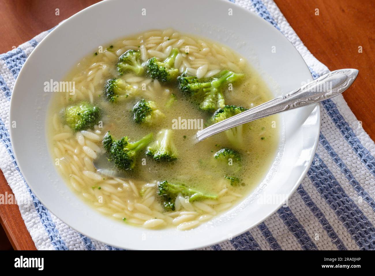 Soup with broccoli cabbage and rice pasta in warm chicken broth Stock