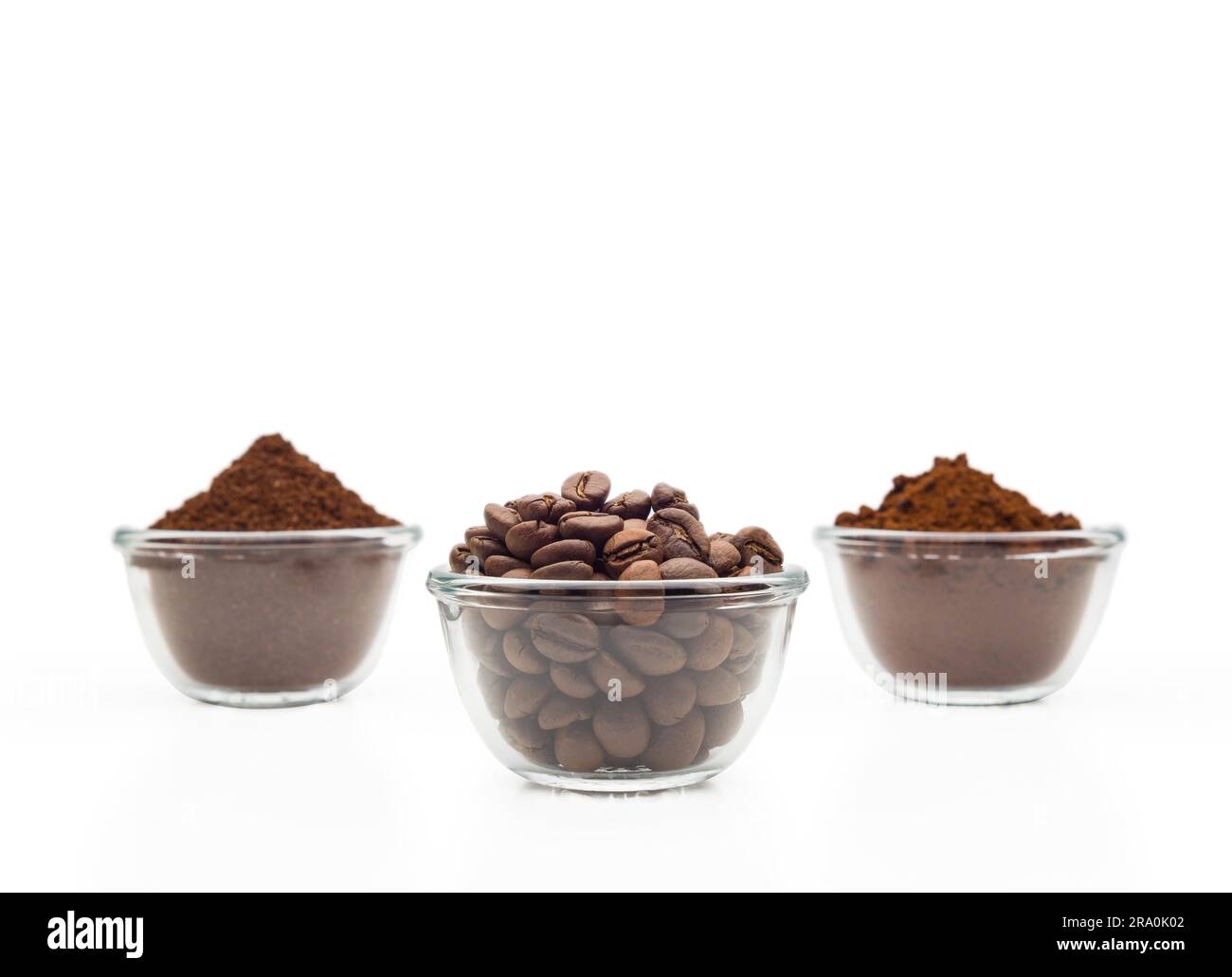 Coffee beans, ground coffee and instant coffee, in little glass cups on