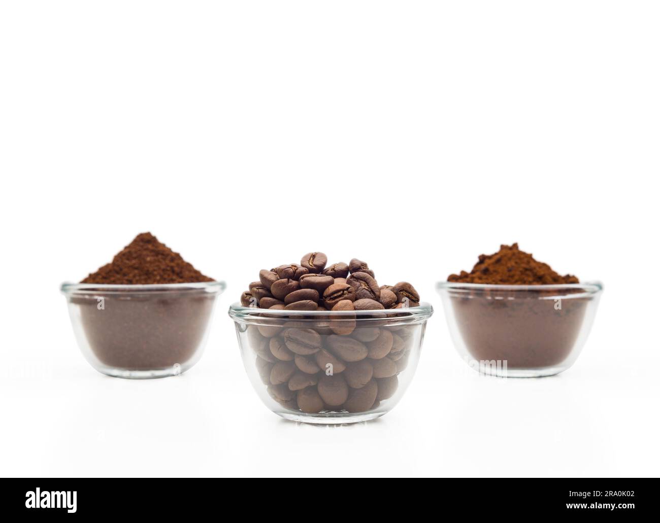 Coffee beans, ground coffee and instant coffee, in little glass cups on a clean white background Stock Photo