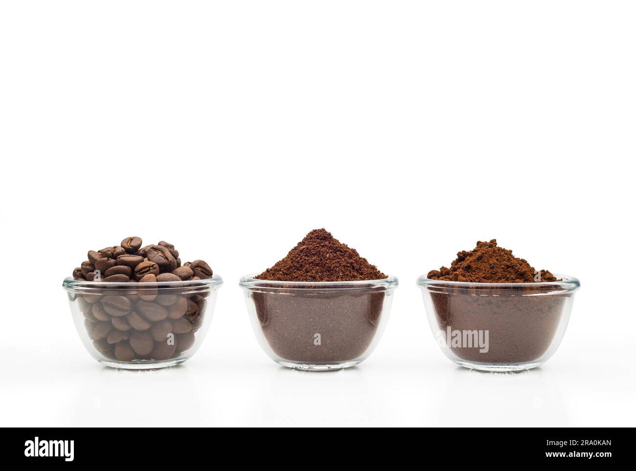 Coffee beans, ground coffee and instant coffee, in little glass cups on a clean white background Stock Photo