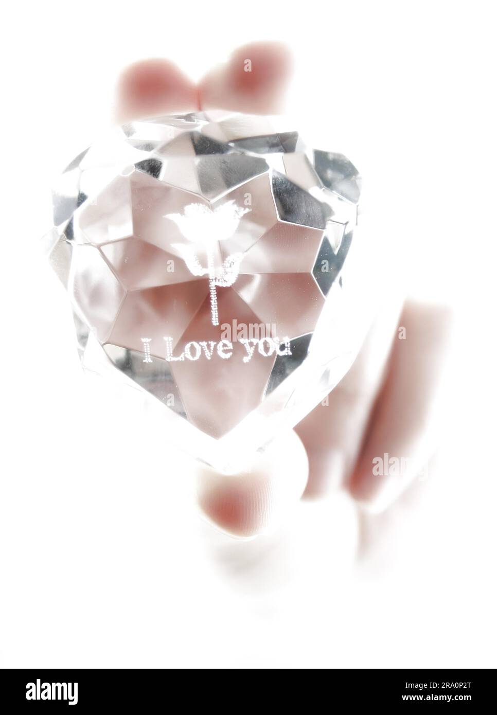 Women's hand holds crystal with declaration of love isolated (high key) Stock Photo