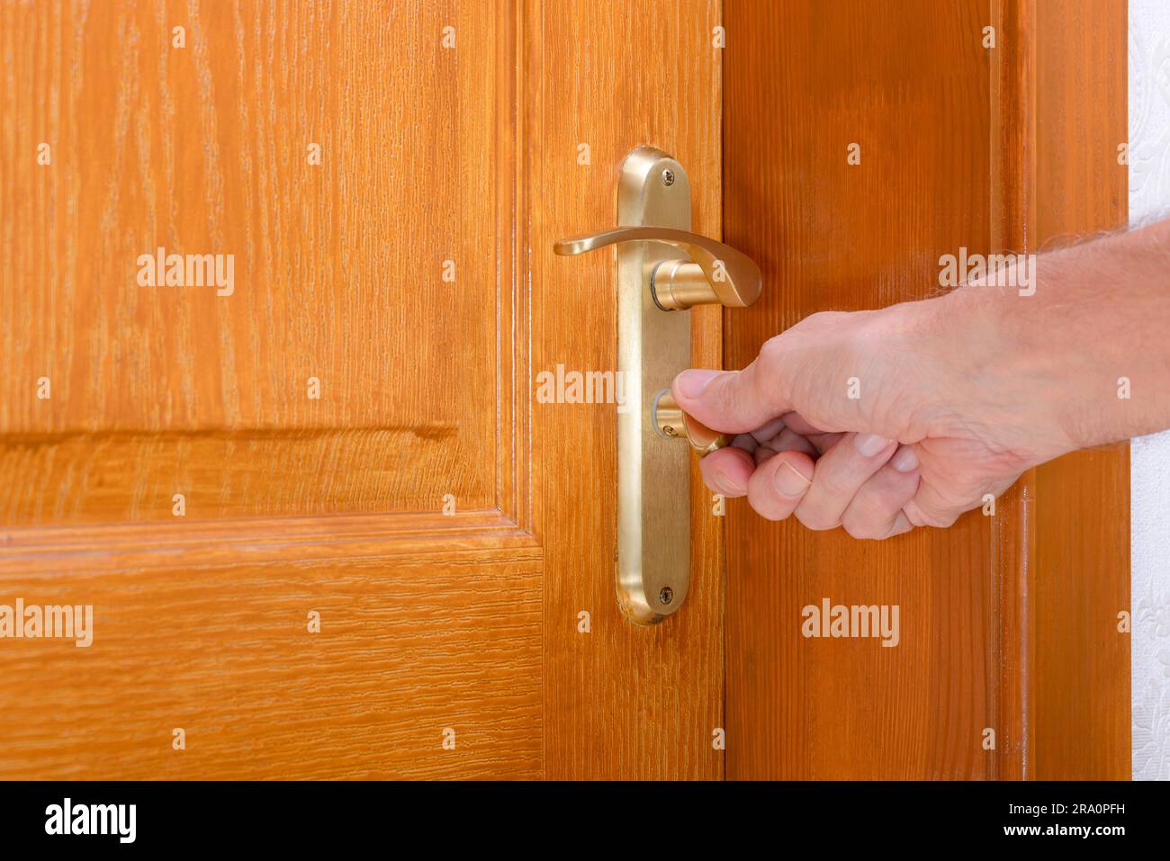 Opening or closing a safety lock on a wooden door Stock Photo Alamy