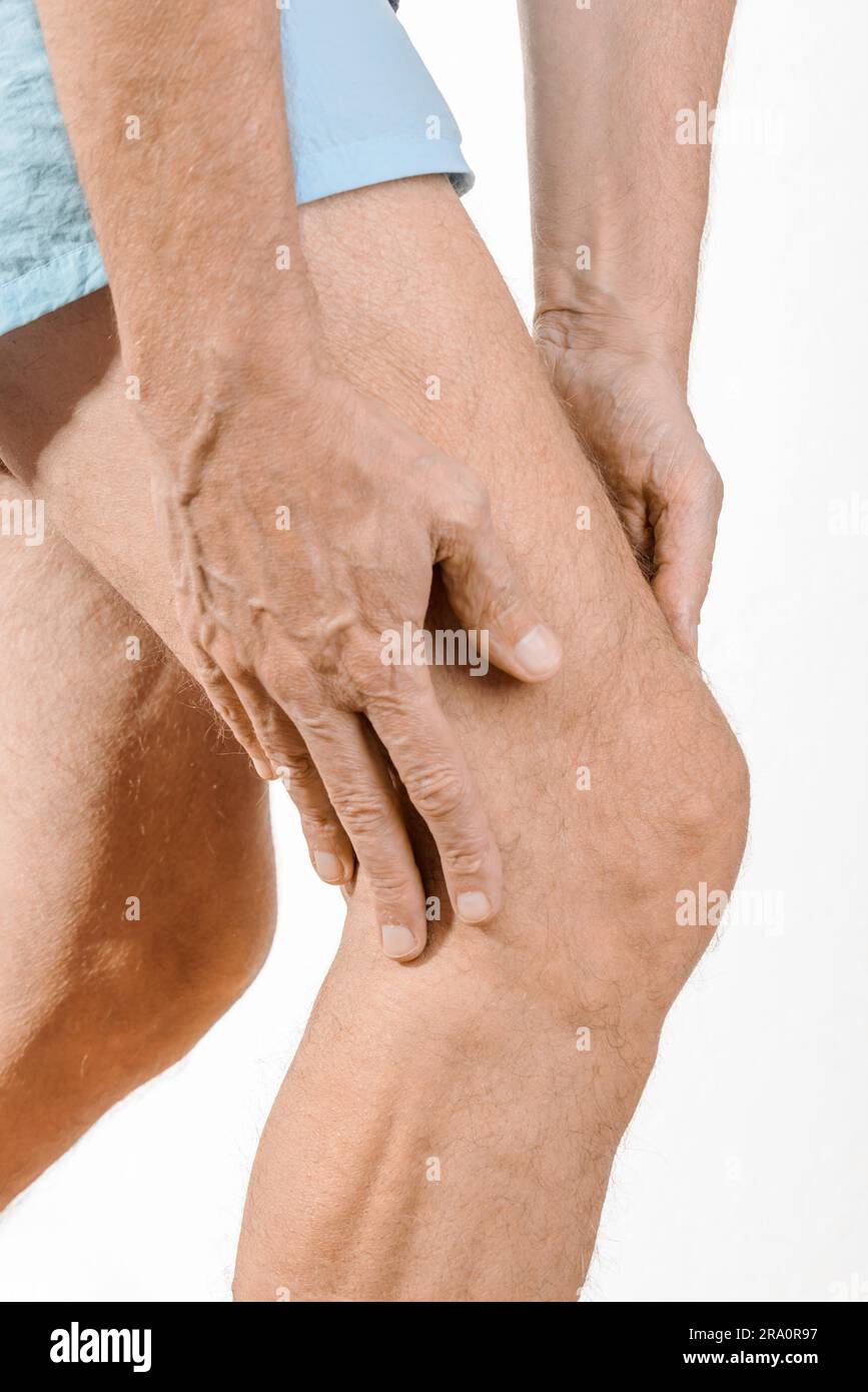 Athlete man massaging a painful quadriceps and the knee after a sport accident. It could be a musculaire claquage, a muscle elongation or an Stock Photo