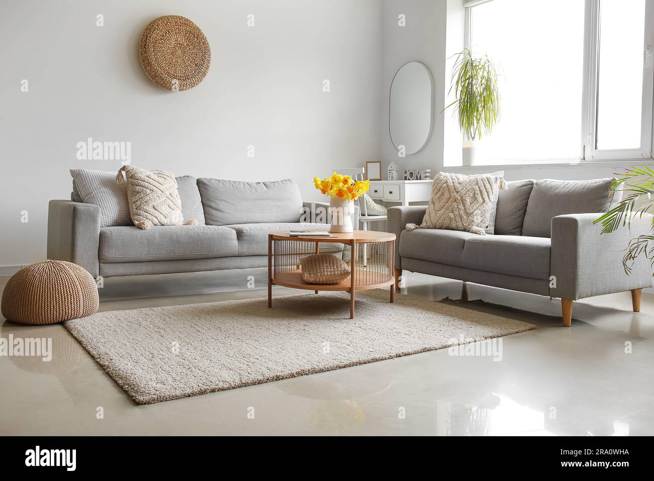 Interior of modern living room with cozy sofas and flower vase on ...