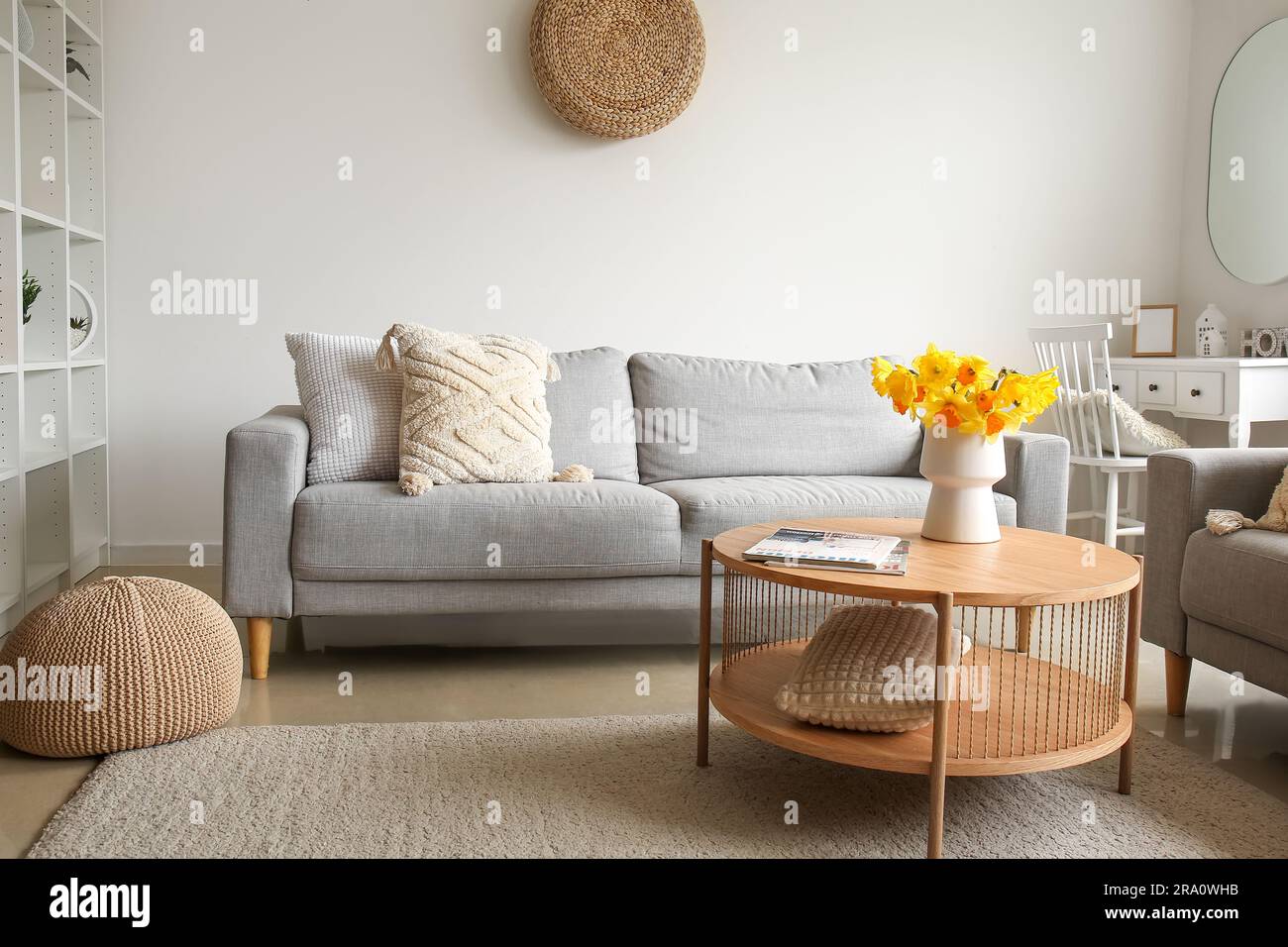 Interior of modern living room with cozy sofa and flower vase on coffee ...