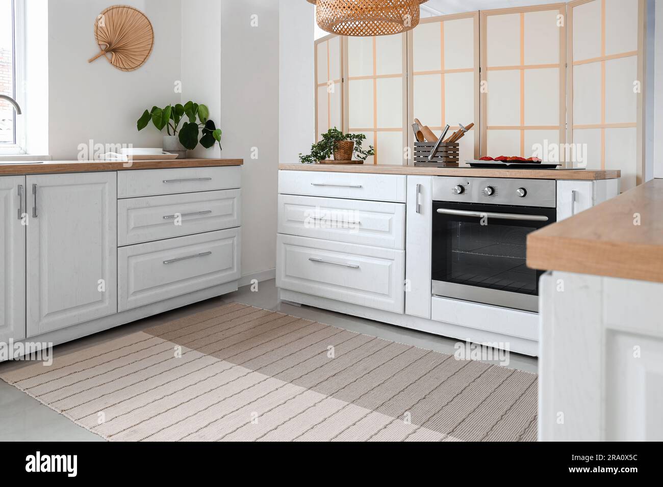 Interior of light kitchen with electric oven and white counters Stock ...