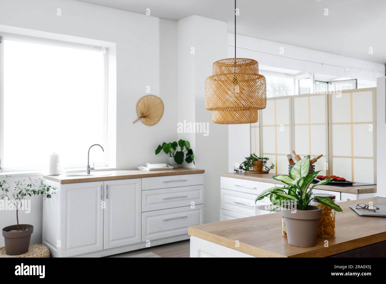 Interior of light kitchen with white counters near window Stock Photo ...
