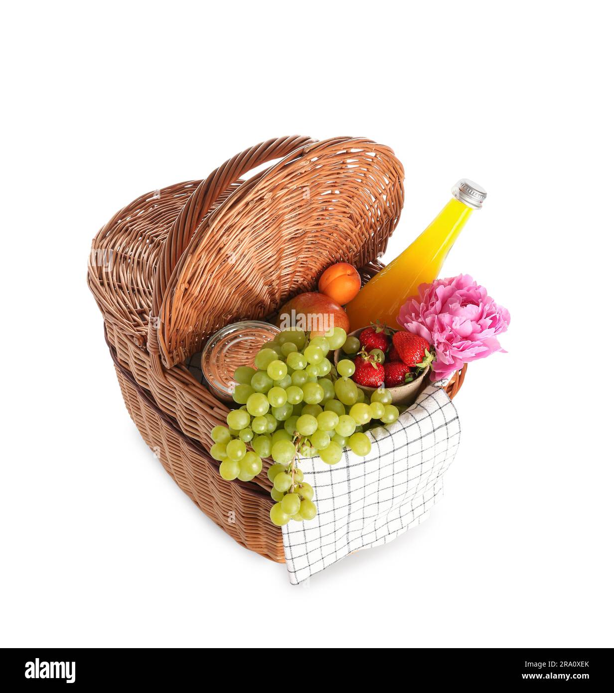 Wicker basket with tasty food for picnic, juice and peony flower on ...