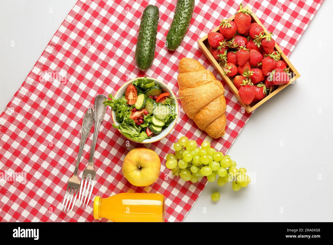 Bowl with salad, tasty food and juice for picnic on white background Stock Photo