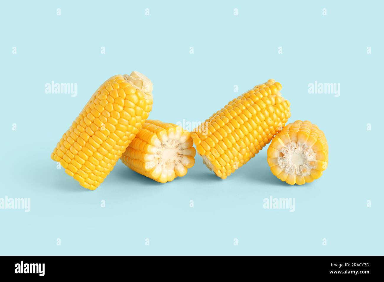 Cut fresh corn cobs on blue background Stock Photo