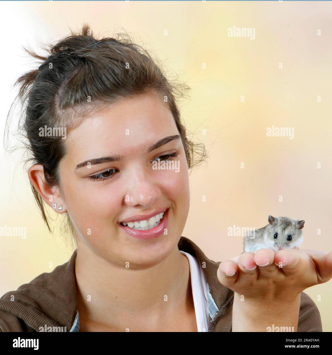 Girl holding Chinese Dwarf Hamster on hand (Cricetulus griseus