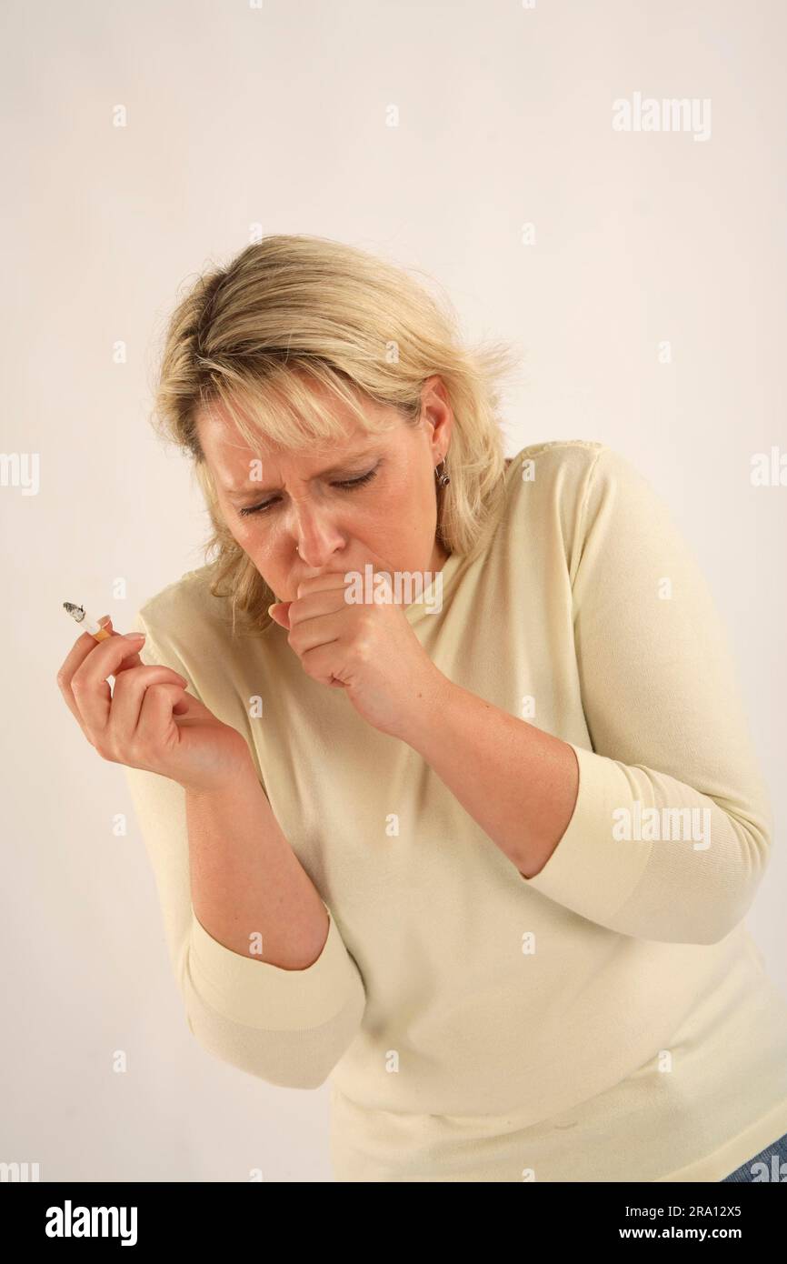 Woman smokes cigarette, smoking, smoker's cough, cough, coughs Stock