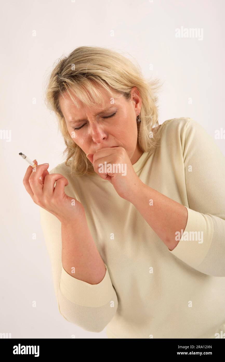 Woman smokes cigarette, smoking, smoker's cough, cough, coughs Stock