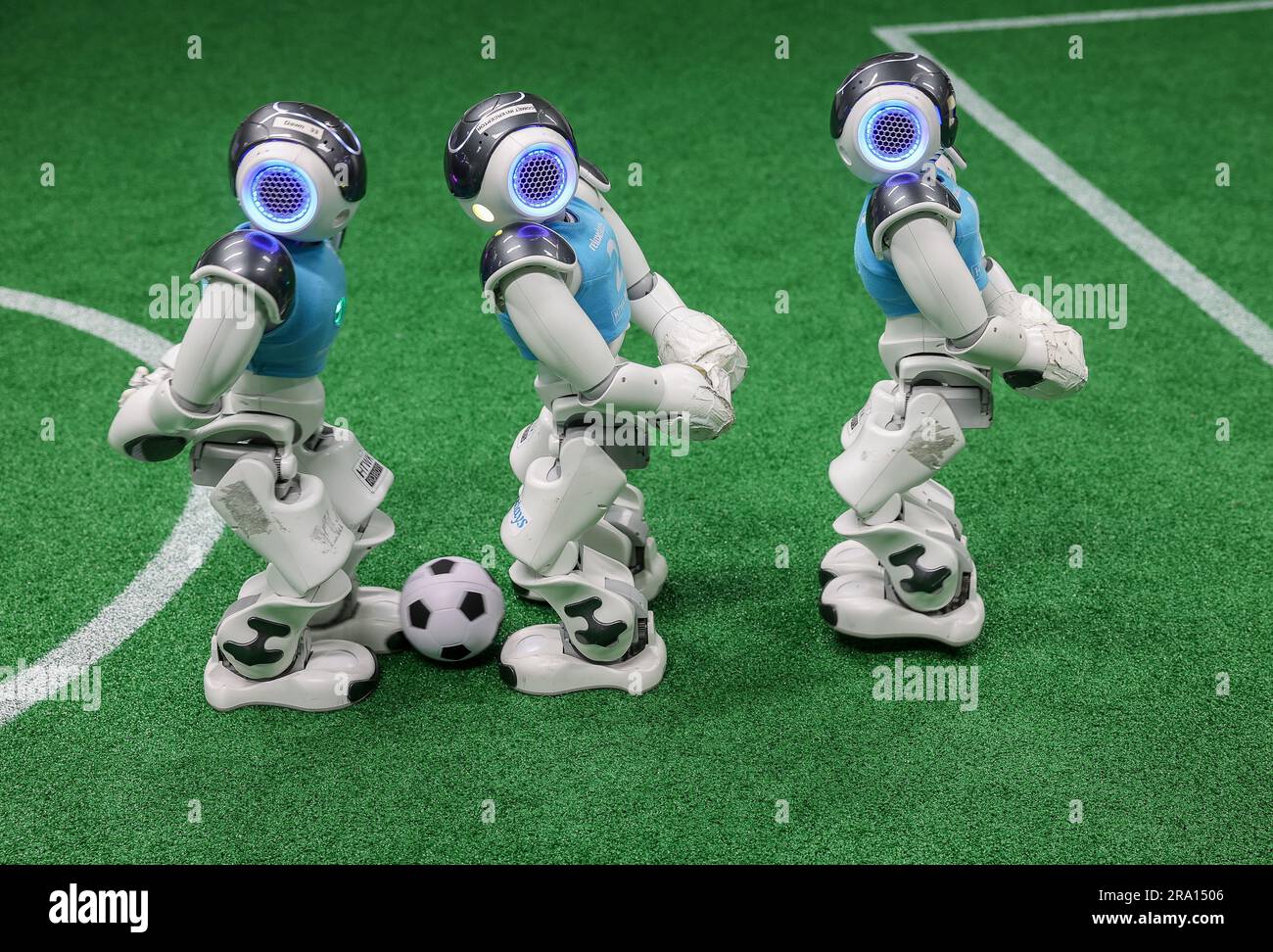 Leipzig, Germany. 28th June, 2023. Three Nao robots play soccer during a training game in a laboratory at the Leipzig University of Applied Sciences (HTWK). Having already become world champions in robot soccer in 2018, the Leipzig team is aiming to secure the title again this year. Starting July 5, robots playing soccer will face off in a World Cup in Bordeaux, France. Credit: Jan Woitas/dpa/Alamy Live News Stock Photo