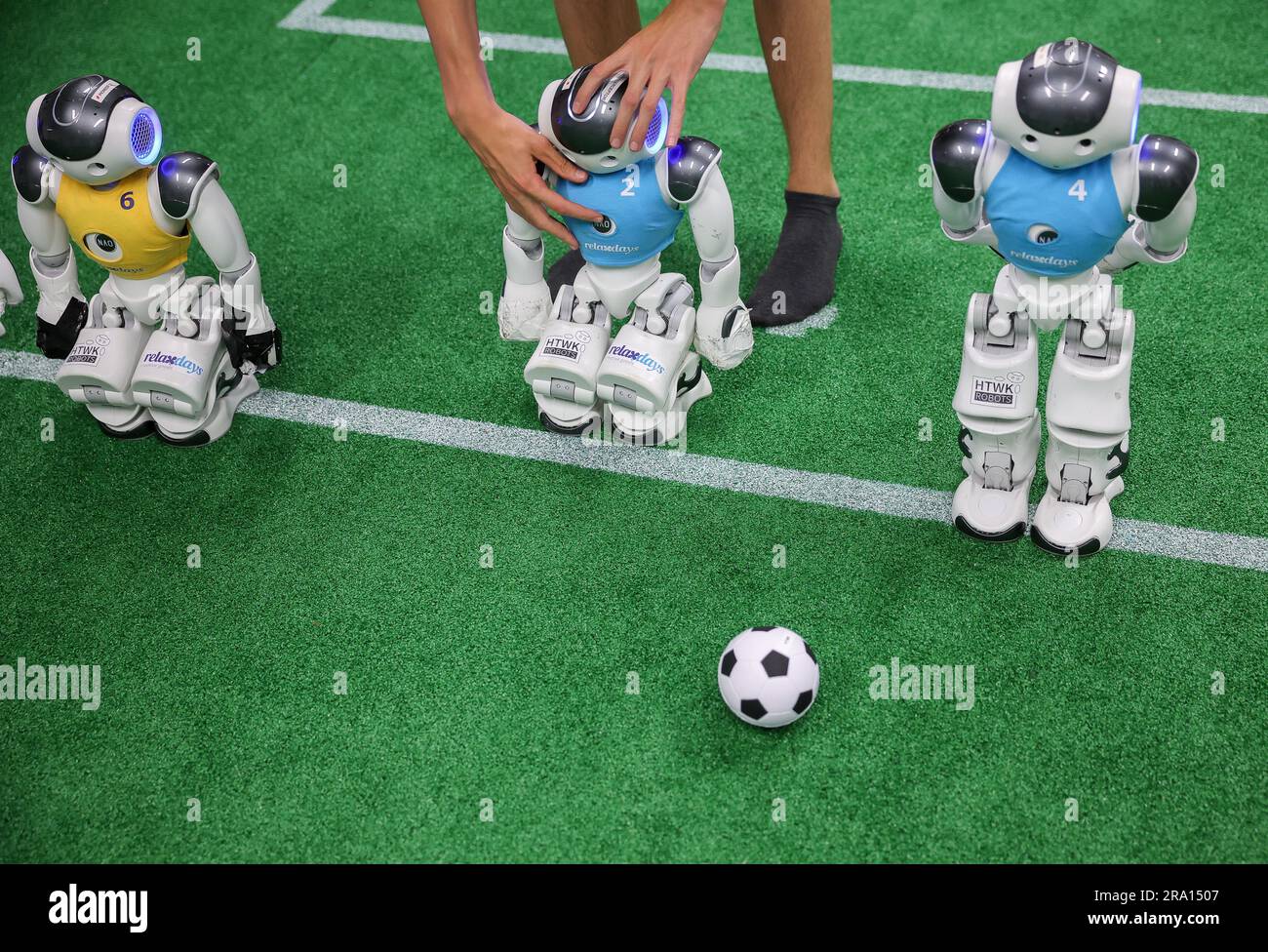 Leipzig, Germany. 28th June, 2023. A student activates Nao robots for a training game in a laboratory at the Leipzig University of Applied Sciences (HTWK). Having already become world champions in robot soccer in 2018, the Leipzig team is aiming to secure the title again this year. Starting July 5, robots playing soccer will face off in a World Cup in Bordeaux, France. Credit: Jan Woitas/dpa/Alamy Live News Stock Photo