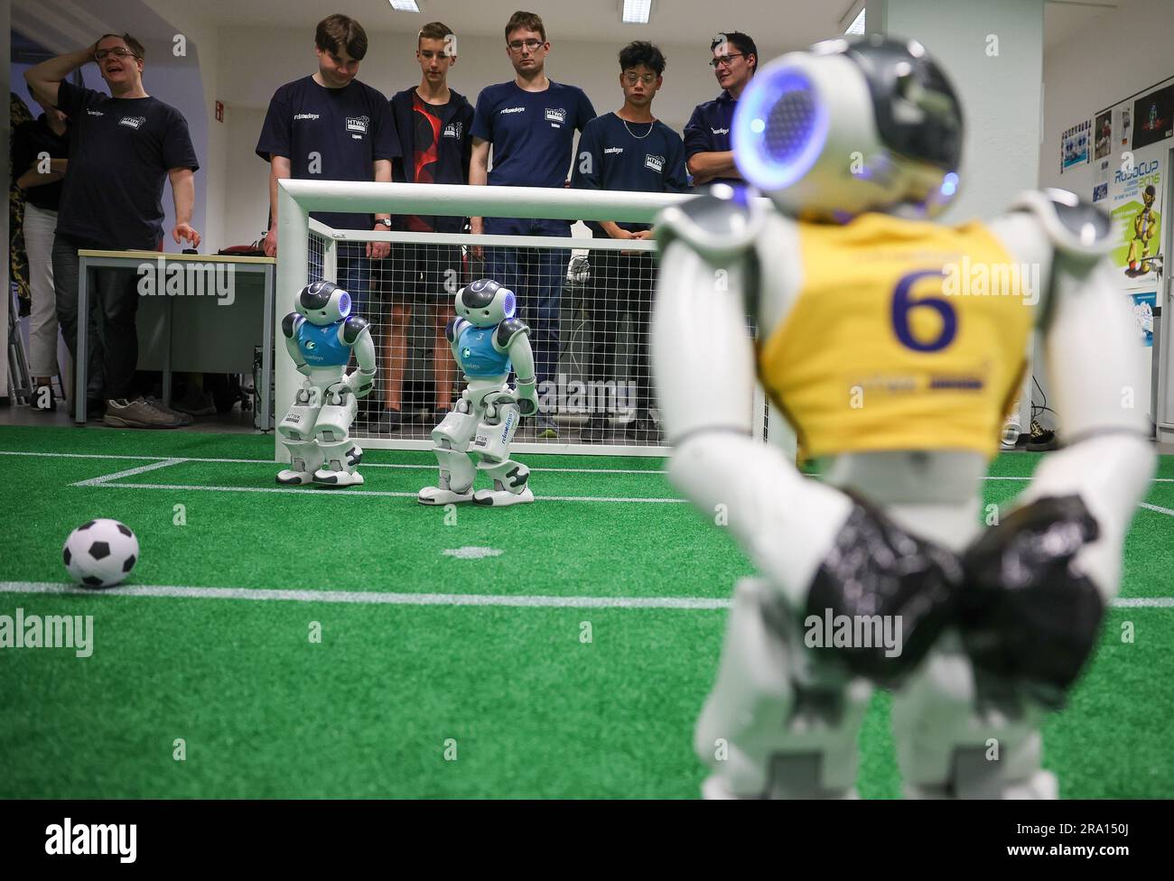 Leipzig, Germany. 28th June, 2023. Nao robots play soccer during a training game in a laboratory at the Leipzig University of Applied Sciences (HTWK). Having already become world champions in robot soccer in 2018, the Leipzig team is aiming to secure the title again this year. Starting July 5, robots playing soccer will face off in a World Cup in Bordeaux, France. Credit: Jan Woitas/dpa/Alamy Live News Stock Photo