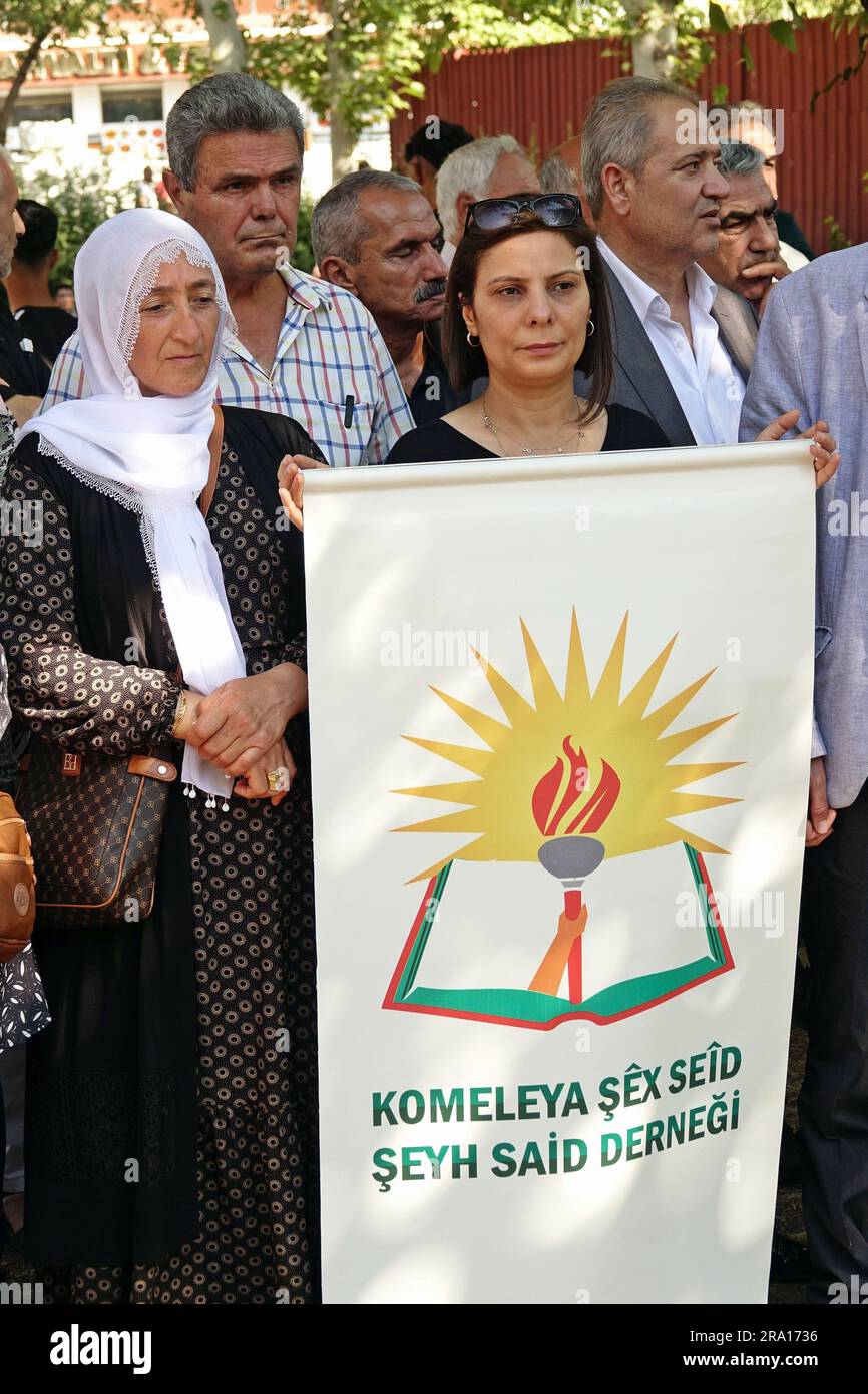 Diyarbakir, Turkey, 29/06/2023, A Kurdish woman holds a pennant of the Sheikh Said association during the memorial ceremony for the Kurdish leader Sheikh Said and his friends, who were executed 98 years ago Kurdish leader Sheikh Said and 46 of his friends were commemorated on the 98th anniversary of their execution, at the place where they were executed in Diyarbakir. Kasim Firat, President of the Association and grandson of Sheikh Said, Saliha Aydeniz, Co-Chairman of the Democratic Regions Party (DBP), members of the Green Left Party (YSP) and Peoples' Democratic Party (HDP), representatives  Stock Photo