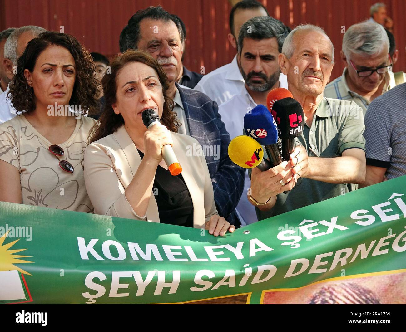 Diyarbakir, Turkey, 29/06/2023, Saliha Aydeniz (L2), Co-Leader of the Democratic Regions Party (DBP), is seen speaking during the memorial ceremony for Kurdish leader Sheikh Said. Kurdish leader Sheikh Said and 46 of his friends were commemorated on the 98th anniversary of their execution, at the place where they were executed in Diyarbakir. Kasim Firat, President of the Association and grandson of Sheikh Said, Saliha Aydeniz, Co-Chairman of the Democratic Regions Party (DBP), members of the Green Left Party (YSP) and Peoples' Democratic Party (HDP), representatives of the Diyarbakir Bar Assoc Stock Photo