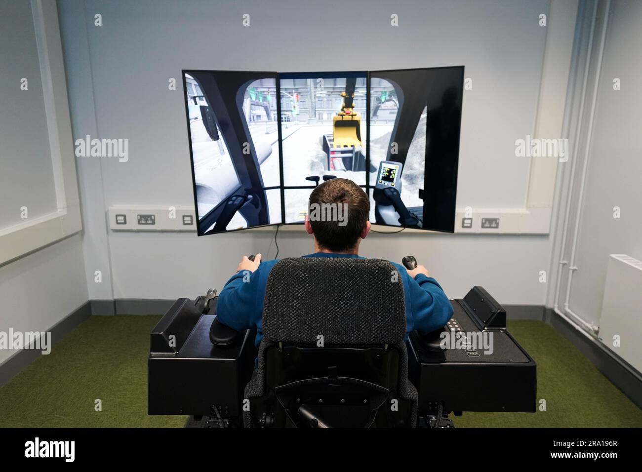 An inmate uses a construction simulator during the official opening of HMP Fosse Way, the new Category C prison in Leicester. Picture date: Thursday June 29, 2023. Stock Photo