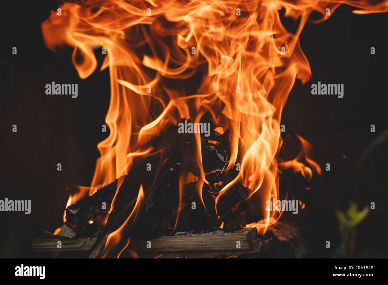 Dry wood crackles under the high temperature and the flames whip up to