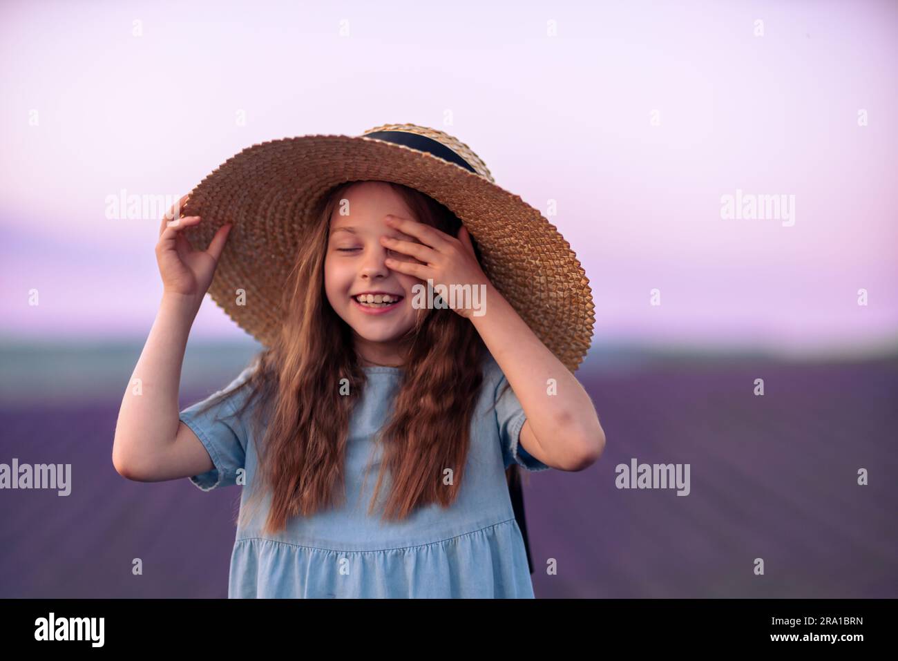 Girl lavender field. Laughing girl in a blue dress with flowing hair in ...