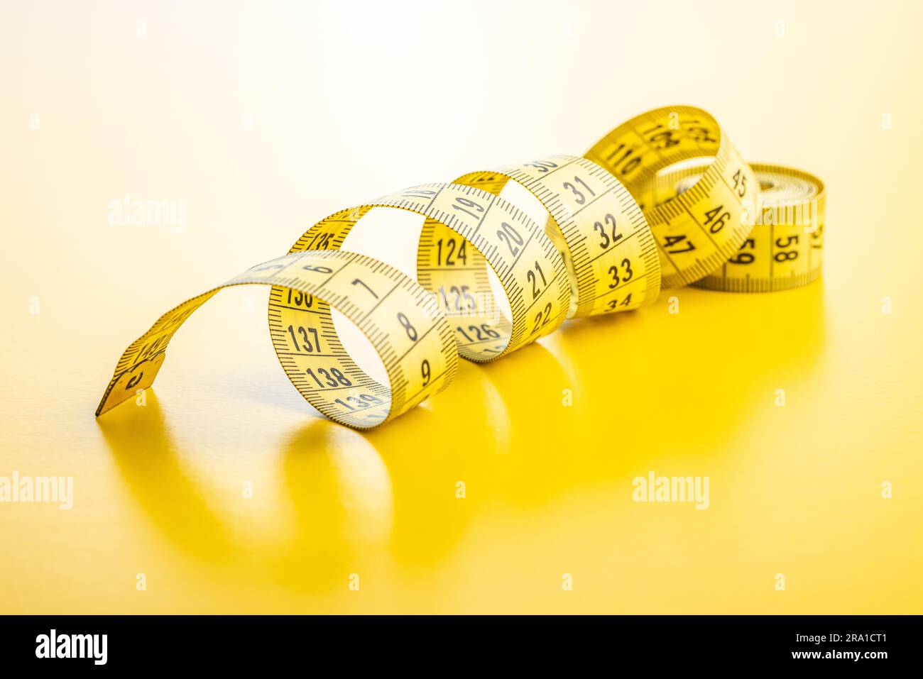 Yellow flexible tape measure Stock Photo - Alamy