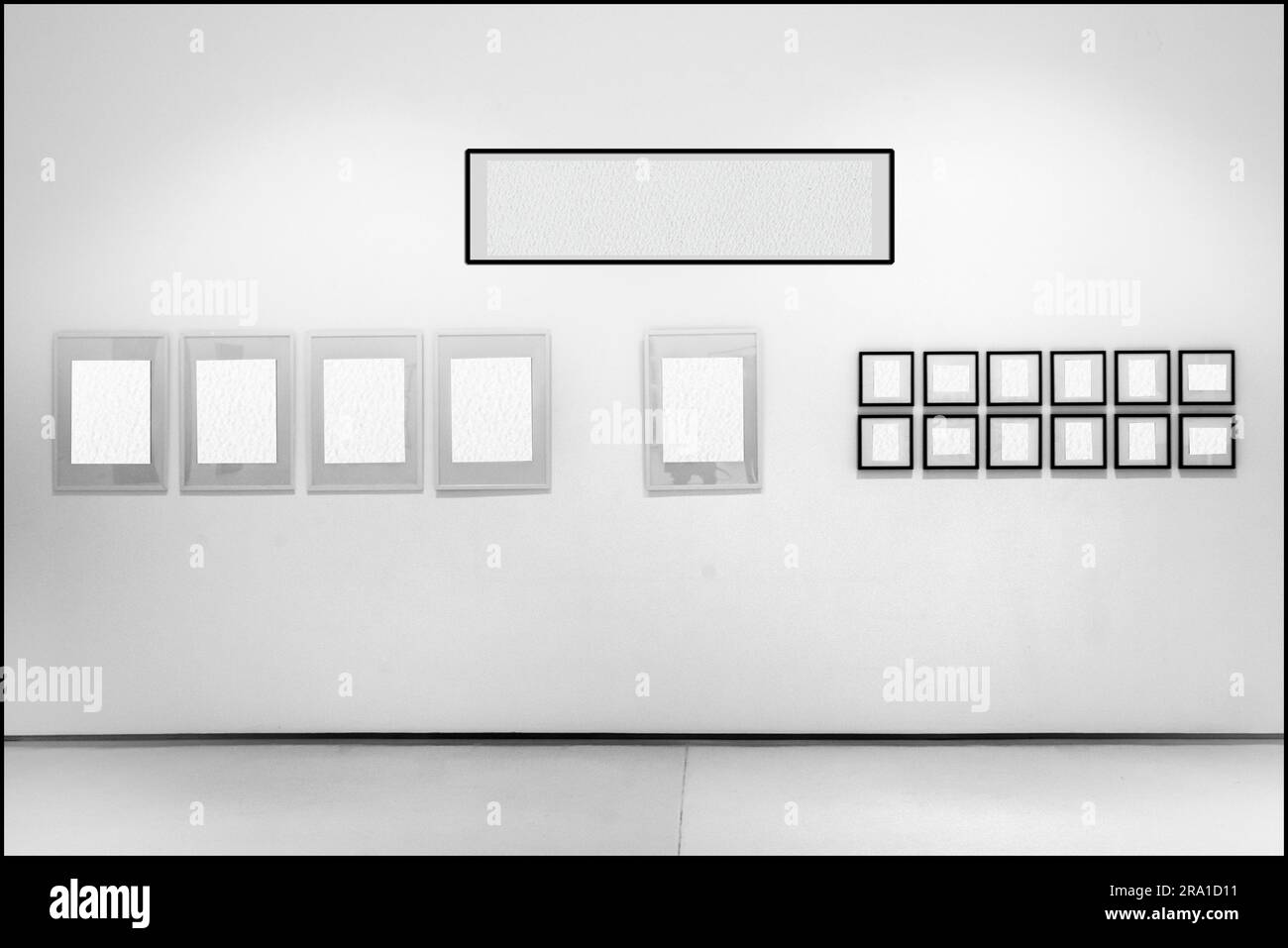 In the whitewalled showroom, frames with empty interiors are exhibited