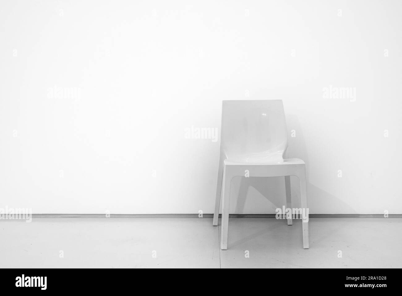 Architecture. White room interior. Empty ambient background. White wall with chair, armchair, white. Stock Photo