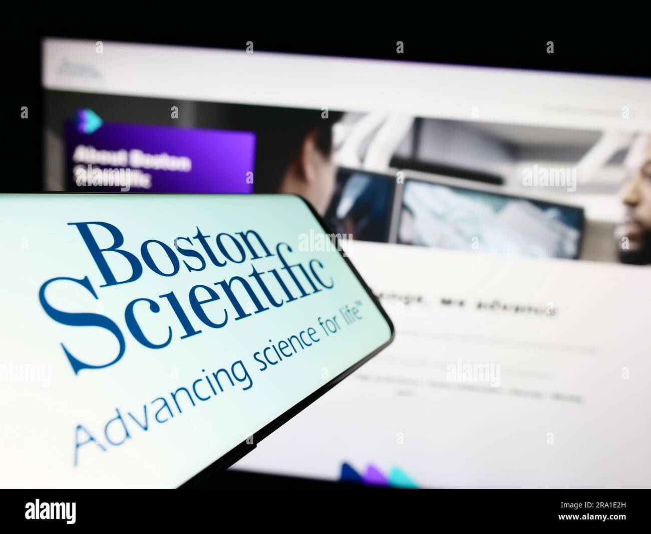 Smartphone with logo of American company Boston Scientific Corporation on screen in front of business website. Focus on center of phone display. Stock Photo