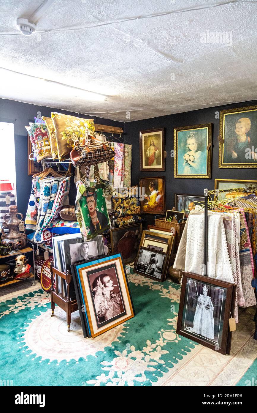 Vintage home textiles and framed pictures at the North Laine Bazaar flea market, Brighton, East Sussex, England Stock Photo