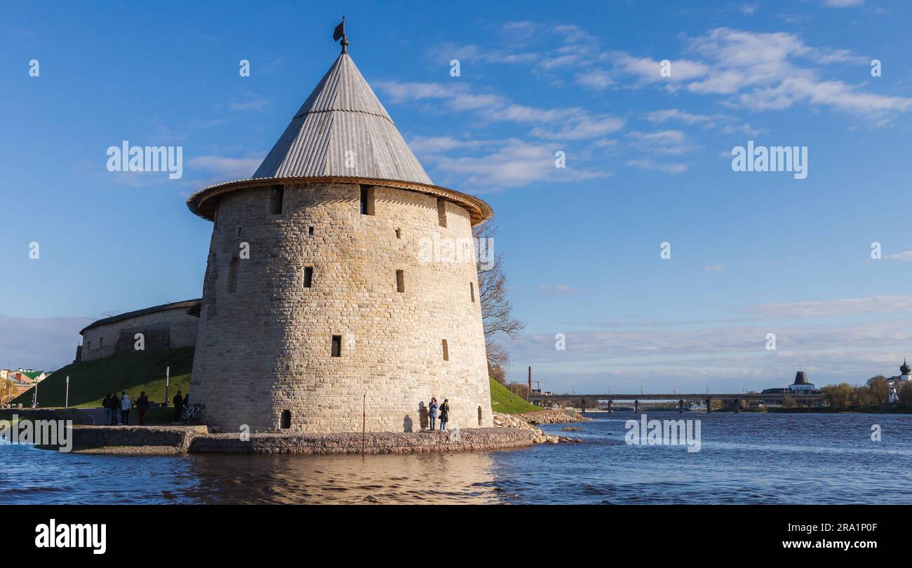 Pskov, Russia - May 3, 2021: Coastal round tower of the Pskov Krom, an ancient Russian citadel. People walk the coast Stock Photo