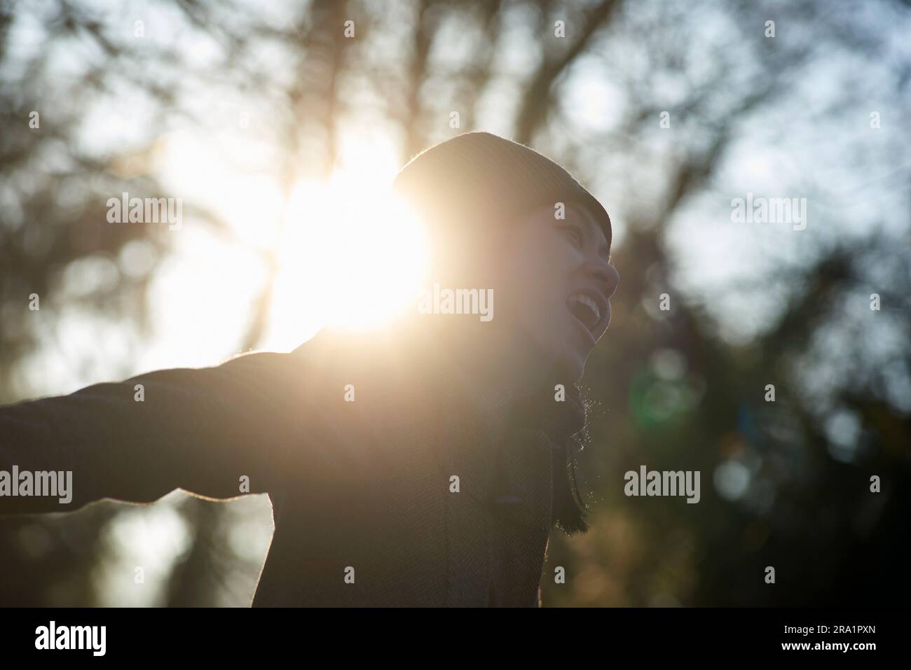 Asian woman enjoying the cold weather with wide open arms Stock Photo