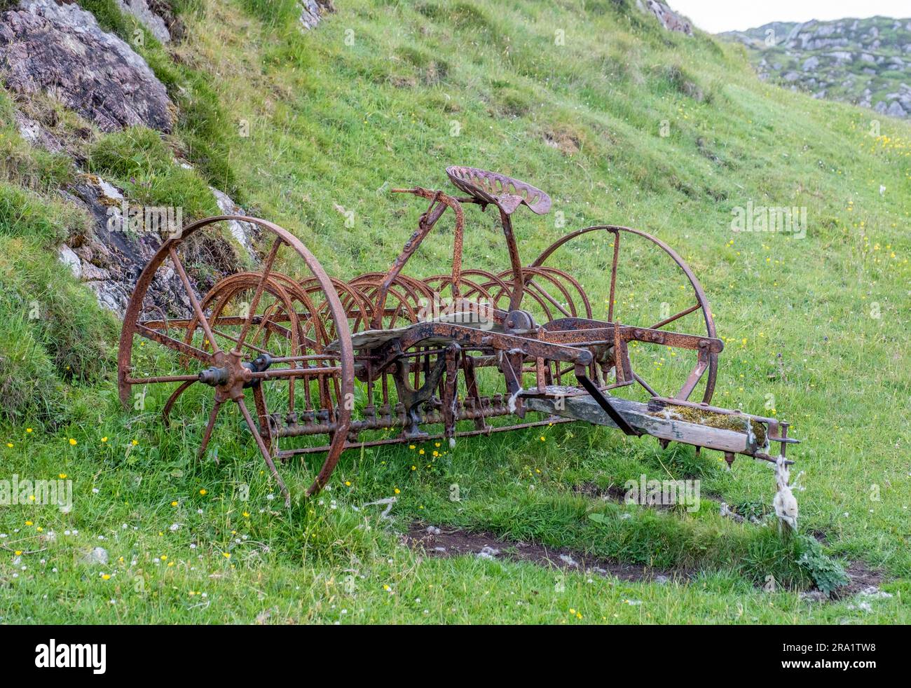 Abandoned hay making machine ( Tumbling Tam) Bousd, Isle of Coll, Inner Hebrides, Scotland, UK. Stock Photo