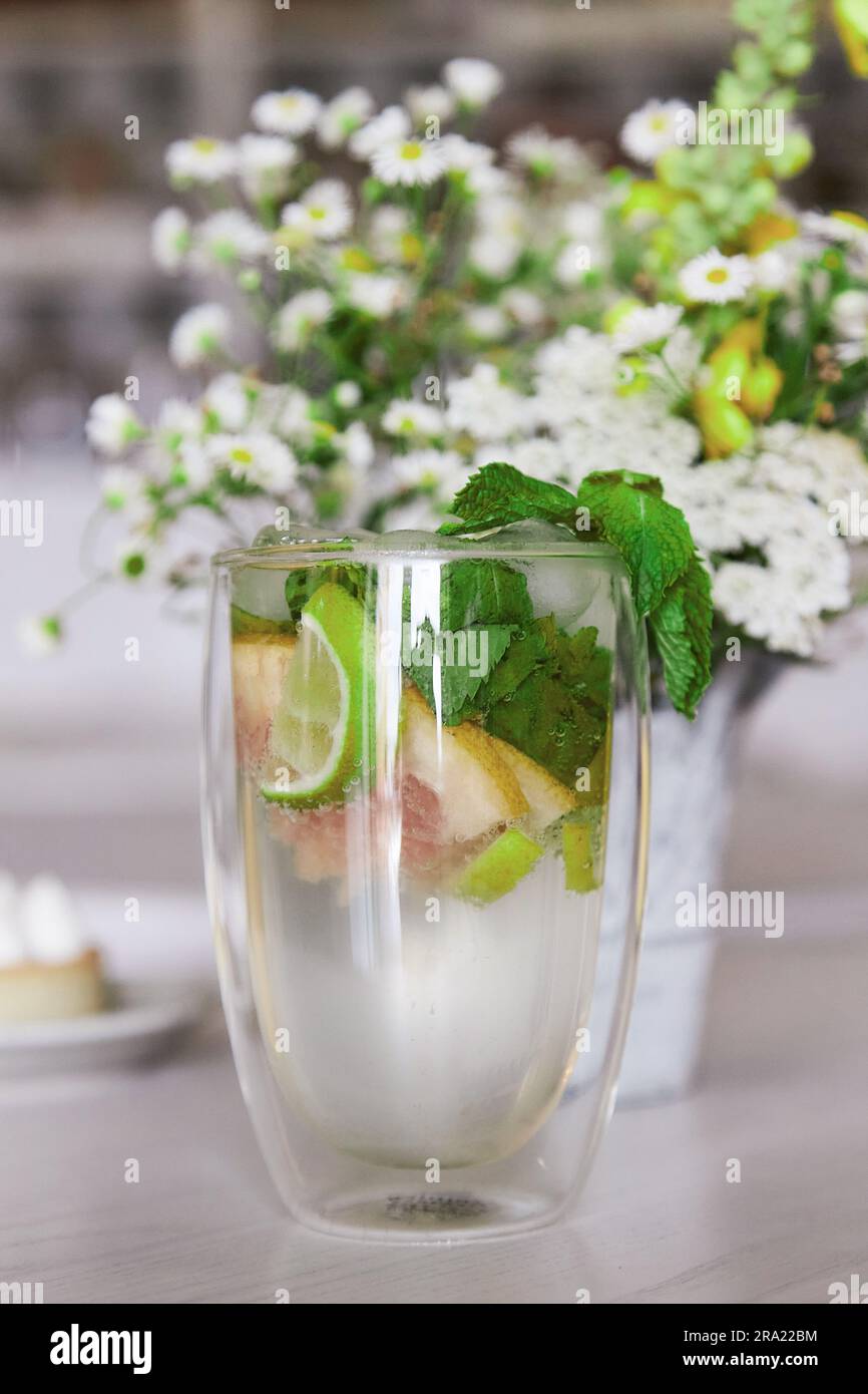 Summer non-alcoholic mojito with fresh mint in the cafe interior. Refreshing drink. Stock Photo