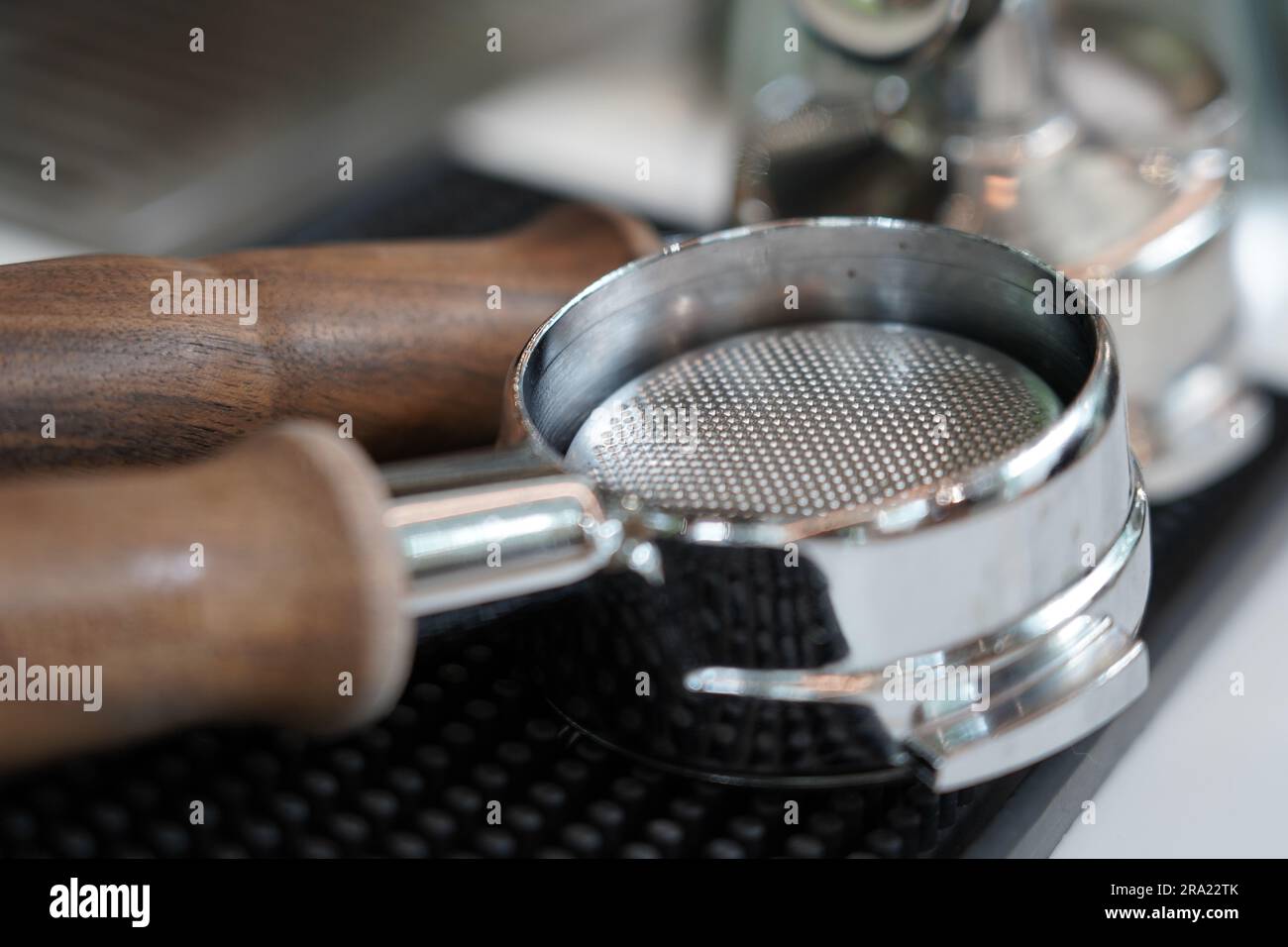 Close up shot of two traditional wooden-handled coffee makers, both with long spouts Stock Photo