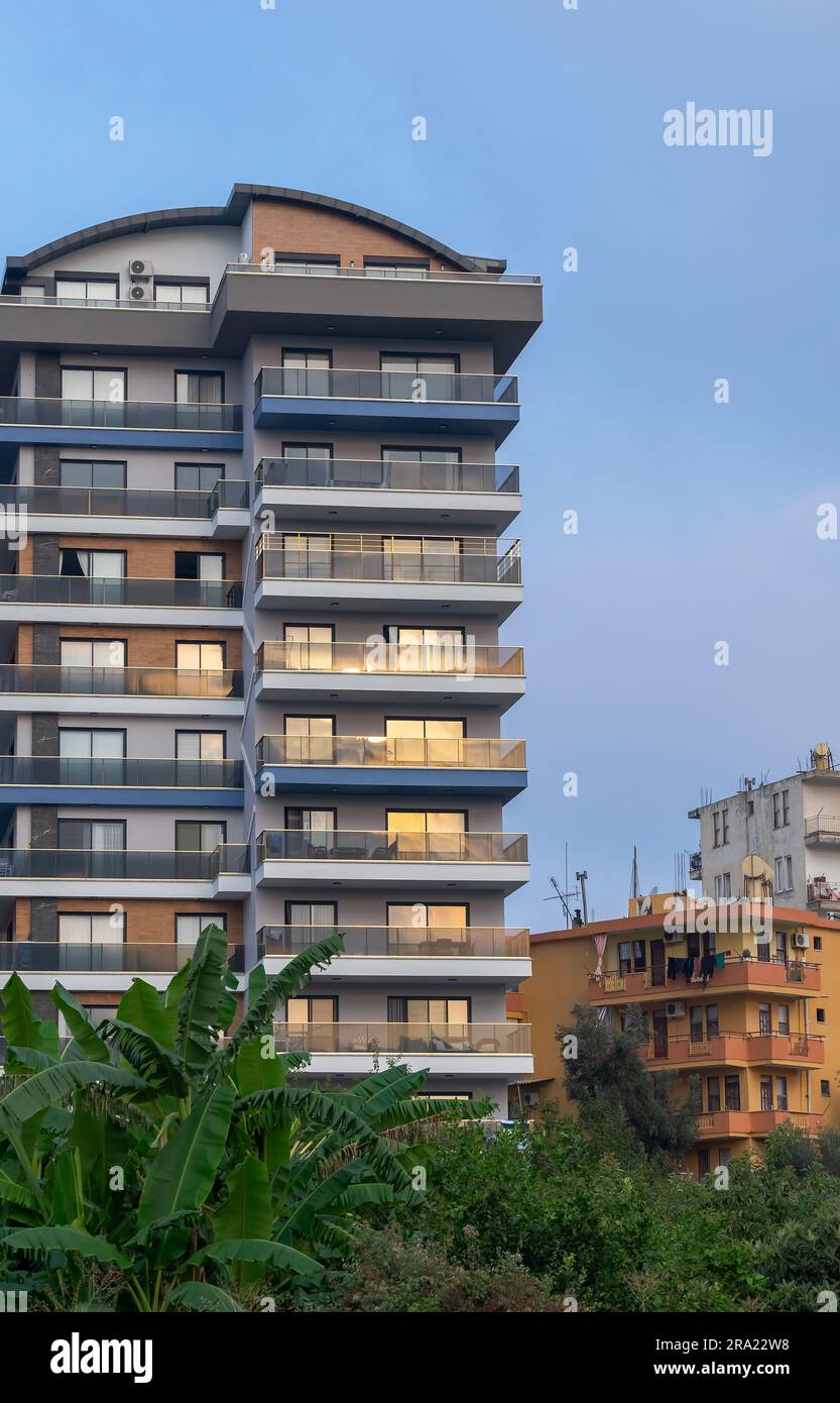 A new luxurious high-rise residential building standing next to the old ...