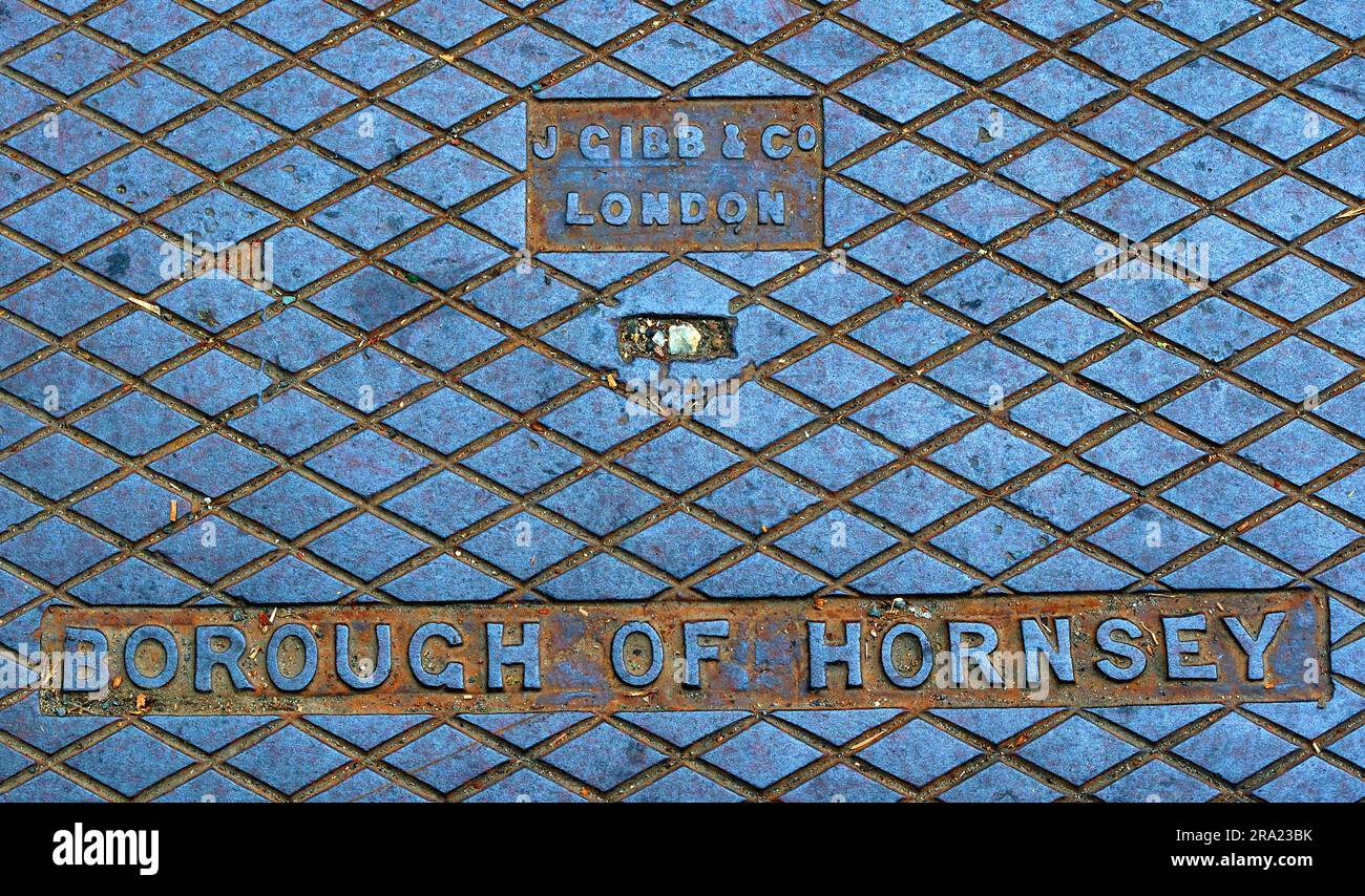 Close-up of a cast iron street grid stamped “Borough of Hornsey” and “J Gibb & Co, London” Stock Photo
