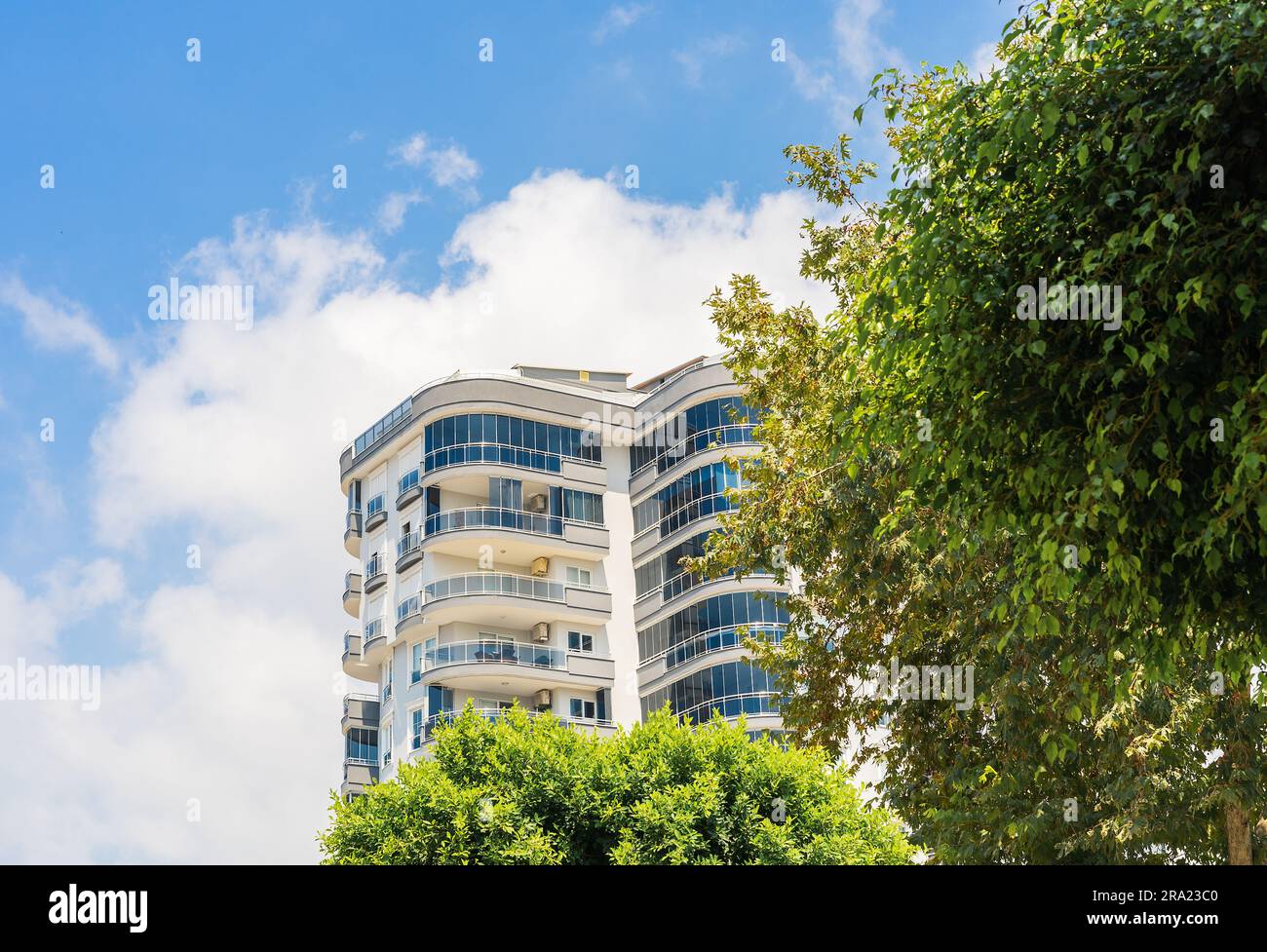 Image showcasing Exterior of a high-rise apartment building. Large balconies. Sunny day ...