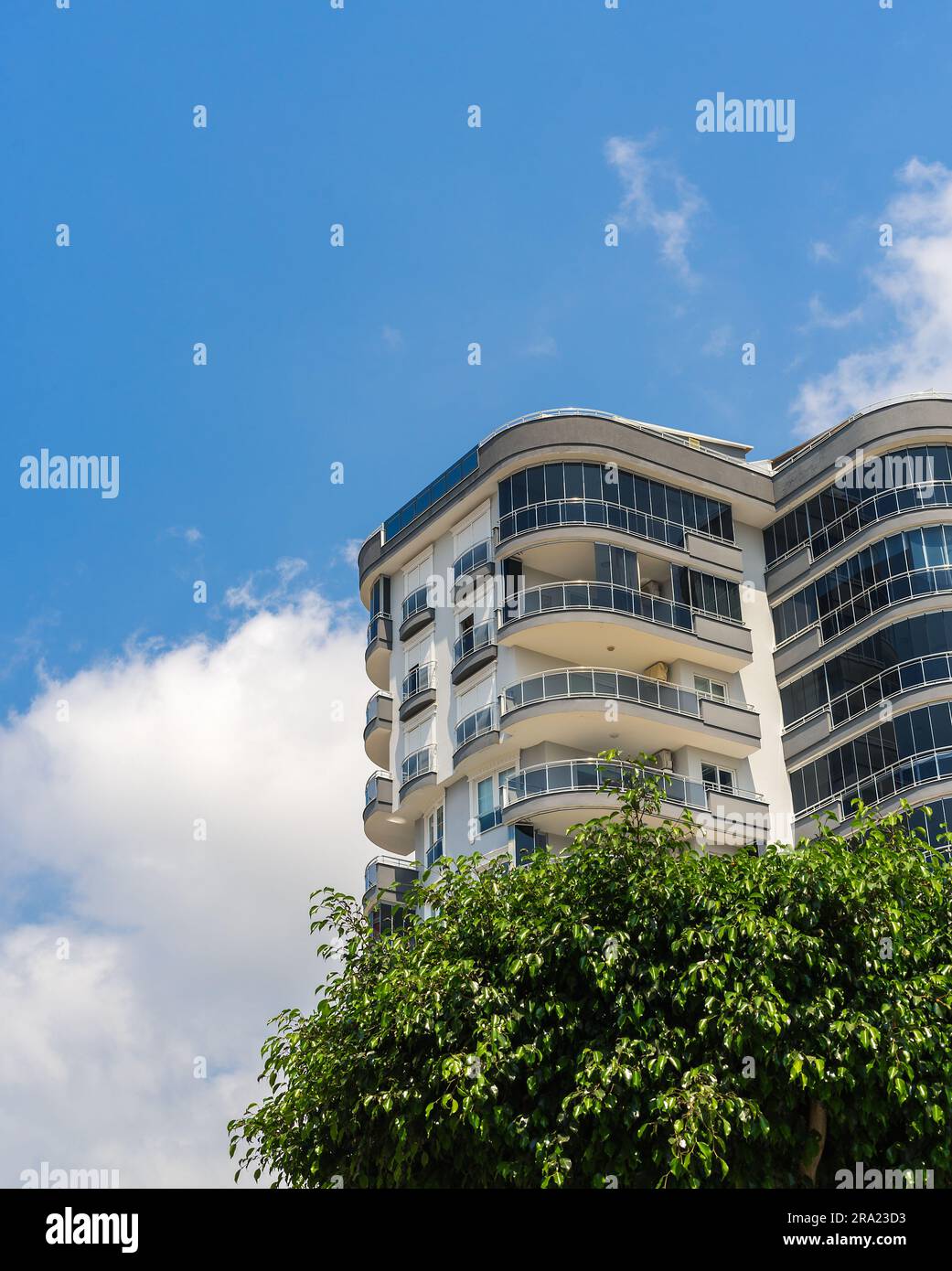 View of Exterior of a high-rise apartment building. Large balconies. Sunny day ...