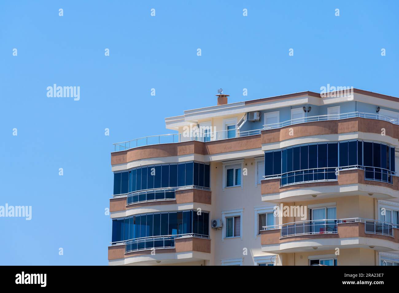 Picture of Exterior of a high-rise apartment building. Large balconies. Sunny day ...