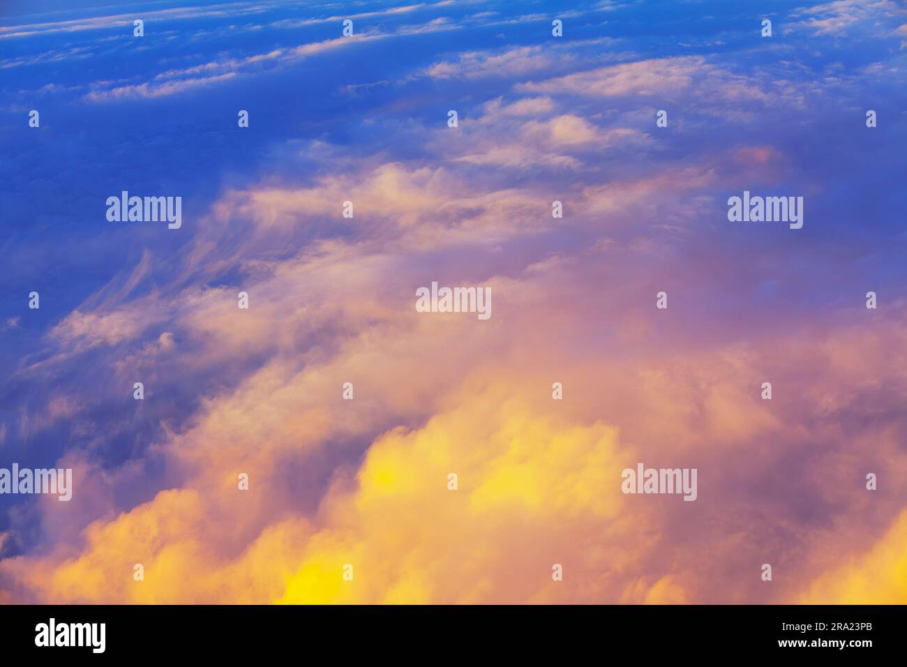 Beautiful cloudscape at sunset as seen through window of an aircraft Stock Photo