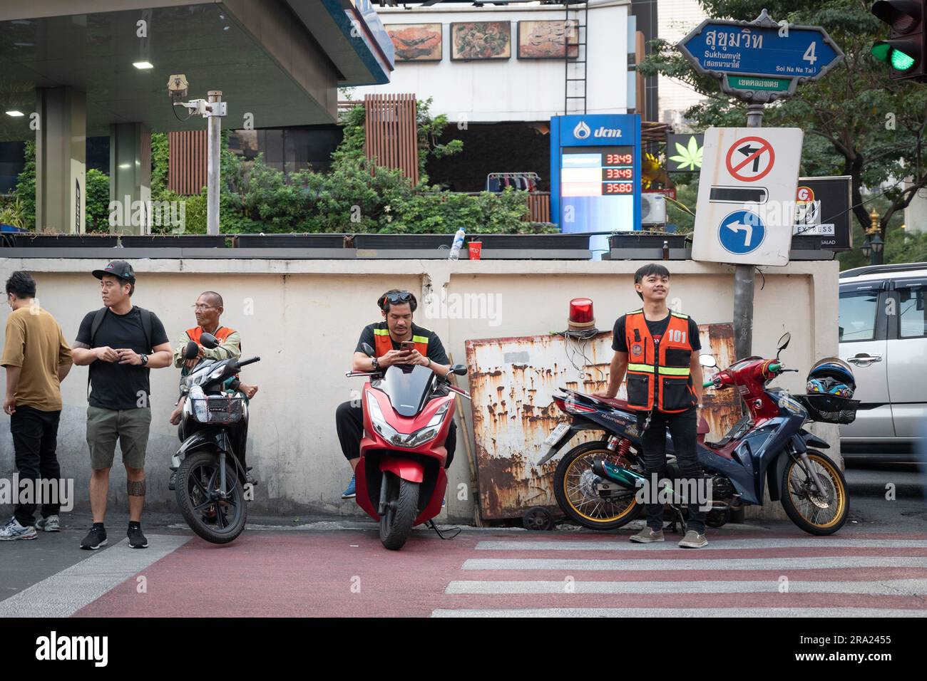 Moped riders and couriers in Bangkok, Thailand Stock Photo
